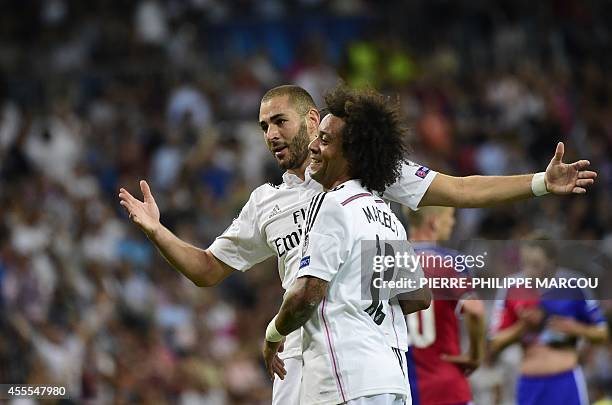 Real Madrid's French forward Karim Benzema celebrates with Real Madrid's Brazilian defender Marcelo after scoring their fifth goal during the UEFA...