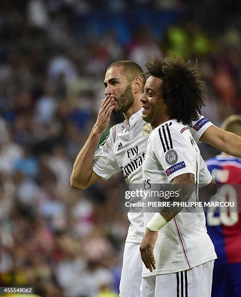 Real Madrid's French forward Karim Benzema celebrates with Real Madrid's Brazilian defender Marcelo after scoring their fifth goal during the UEFA...