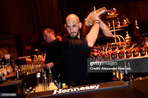 Bartender prepares a cocktail during the Hennessy Very Special Limited Edition by Shepard Fairey launch party at Kraftwerk Mitte on September 16,...