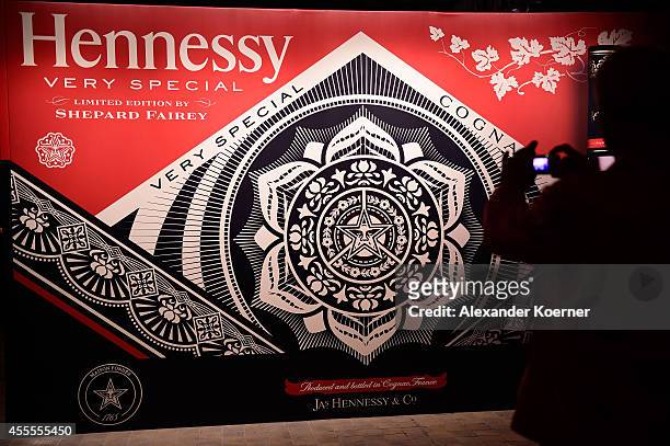 Visitor takes a photo at the Hennessy Very Special Limited Edition by Shepard Fairey launch party at Kraftwerk Mitte on September 16, 2014 in Berlin,...