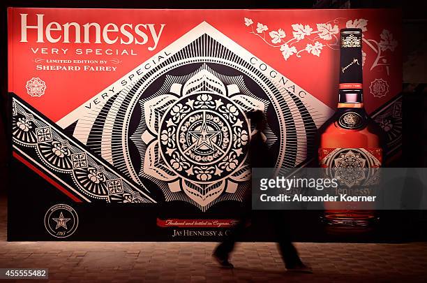 An employee walks through the Hennessy Very Special Limited Edition by Shepard Fairey launch party at Kraftwerk Mitte on September 16, 2014 in...