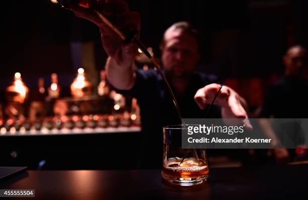 Bartender prepares a cocktail during the Hennessy Very Special Limited Edition by Shepard Fairey launch party at Kraftwerk Mitte on September 16,...