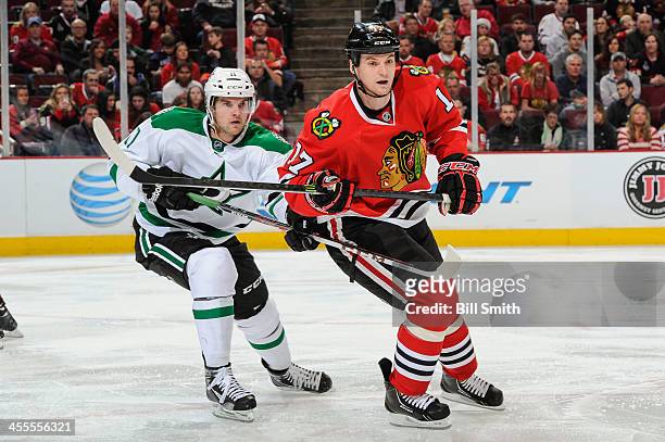 Dustin Jeffrey of the Dallas Stars and Sheldon Brookbank of the Chicago Blackhawks watches for the puck during the NHL game on December 03, 2013 at...