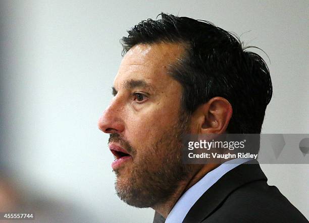 Head Coach Bob Boughner of the Windsor Spitfiers looks on from the bench in the game against the Niagara Ice Dogs at Thorold Arena on September 16,...