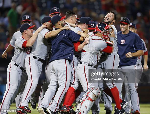 Members of the Washington Nationals celebrate after the division-clinching game against the Atlanta Braves at Turner Field on September 16, 2014 in...