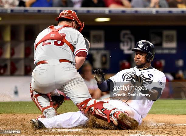 Rymer Liriano of the San Diego Padres scores ahead of the tag of Cameron Rupp of the Philadelphia Phillies during the sixth inning of a baseball game...