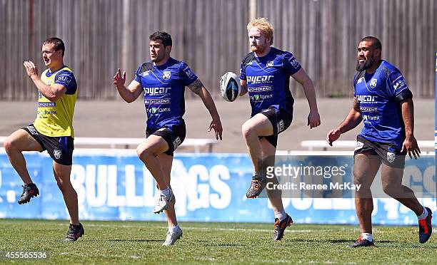 Michael Ennis, James Graham and Frank Pritchard warm up during a Canterbury Bulldogs NRL training session at Belmore Sports Ground on September 17,...