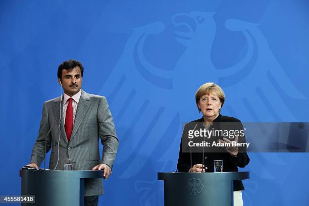 Sheikh Tamim bin Hamad Al Thani, the eighth and current Emir of the State of Qatar , listens during a press conference with German Chancellor Angela...