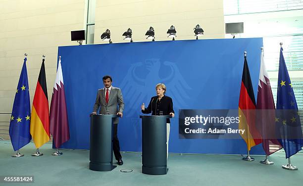 Sheikh Tamim bin Hamad Al Thani, the eighth and current Emir of the State of Qatar , listens during a press conference with German Chancellor Angela...