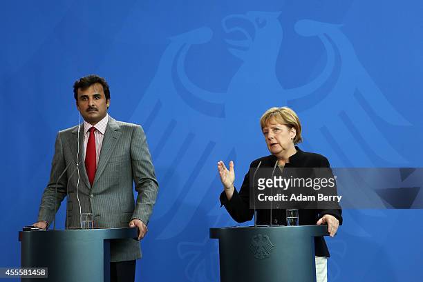 Sheikh Tamim bin Hamad Al Thani, the eighth and current Emir of the State of Qatar , listens during a press conference with German Chancellor Angela...