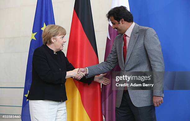 Sheikh Tamim bin Hamad Al Thani, the eighth and current Emir of the State of Qatar , shakes hands with German Chancellor Angela Merkel after a press...