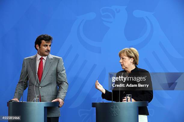 Sheikh Tamim bin Hamad Al Thani, the eighth and current Emir of the State of Qatar , listens during a press conference with German Chancellor Angela...