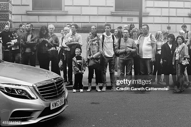 People wait to see guests arrive for the Matthew Williamson show during London Fashion Week Spring Summer 2015 on September 14, 2014 in London,...