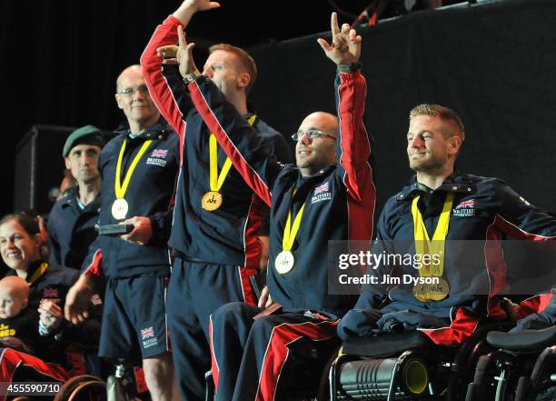 Joe Townsend of Great Britain salutes the crowd with team mates after receiving the Jaguar Award for Exceptional Performance during the Invictus...
