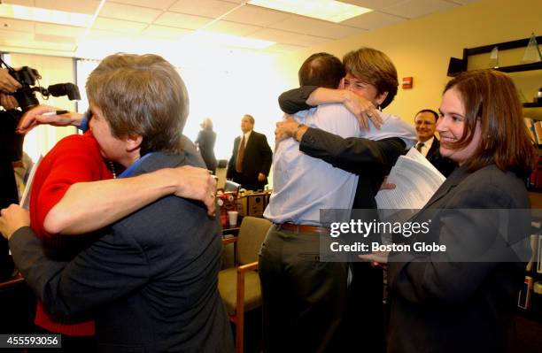 Lead attorney Mary L. Bonauto, on left, hugs plaintiff Ellen Wade, from Newton. Staff attorney Karen Loewy on the right. In the middle plaintiff...