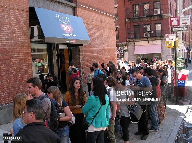 Tourists line up outside a temporary "pop up" reproduction of the "Central Perk" coffee shop, a center piece set of the television situation comedy...