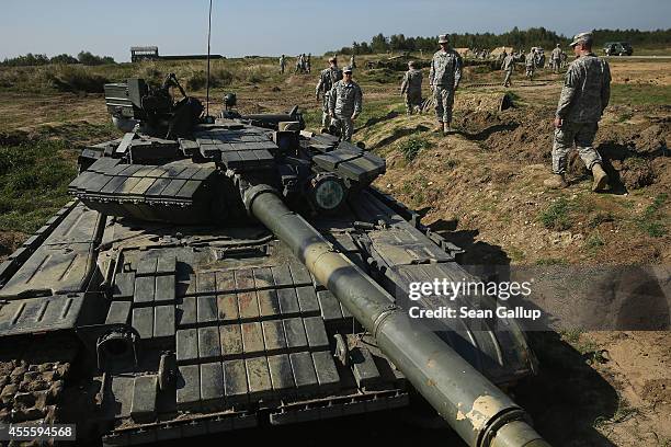 Soldiers examine a Ukrainian T-80 tank on the third day of the 'Rapid Trident' bilateral military exercises between the United States and Ukraine...