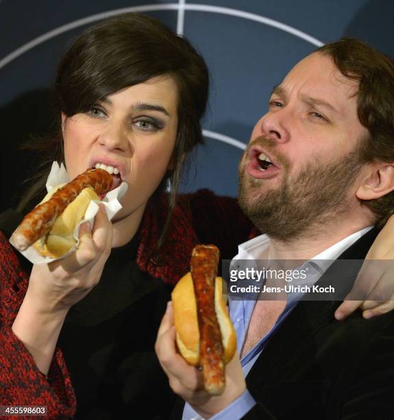 Nora Tschirner and Christian Ulmen eat grilled sausages at the premiere of 'Tatort - Die Fette Hoppe' at Deutschen Nationaltheater on December 12,...