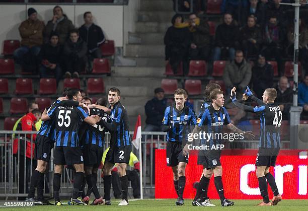 Chomomorets Odessa's Franck Djadjedje is congratulated by teammates after scoring a goal during the Europa League football match Eindhoven vs Odessa...