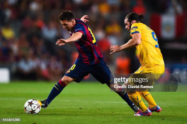 Lionel Messi of FC Barcelona competes for the ball with Cillian Sheridan of APOEL FC during the UEFA Champions League Group F match between FC...