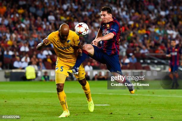 Lionel Messi of FC Barcelona competes for the ball with Carlao of APOEL FC during the UEFA Champions League Group F match between FC Barcelona and...