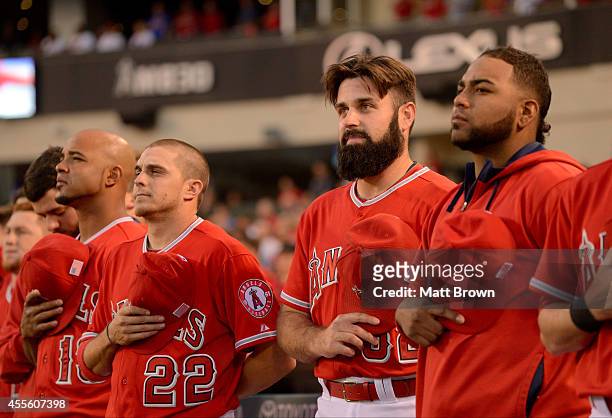 Luis Jimenez, Tony Campana, Matt Shoemaker, and Jairo Diaz of the Los Angeles Angels of Anaheim stand for the national anthem before the game against...