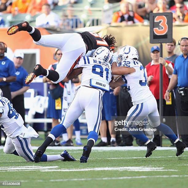 Jonathan Newsome and Colt Anderson of the Indianapolis Colts tackle Alex Smith of the Cincinnati Bengals during their game at Paul Brown Stadium on...