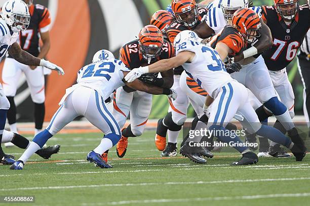 Jeremy Hill of the Cincinnati Bengals runs the football upfield against Colt Anderson of the Indianapolis Colts at Paul Brown Stadium on August 28,...