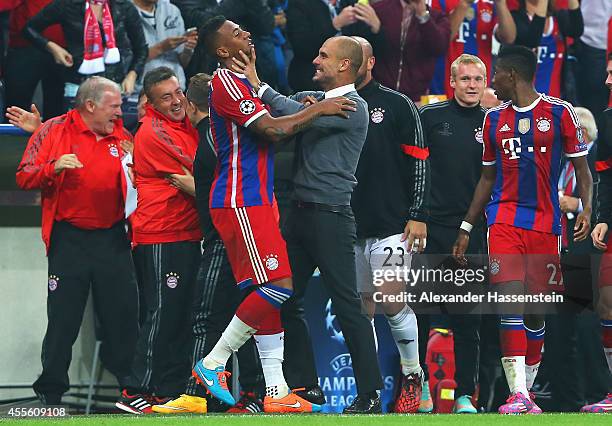 Jerome Boateng of Bayern Muenchen celebrates his goal with coach Josep Guardiola of Bayern Muenchen during the UEFA Champions League Group E match...