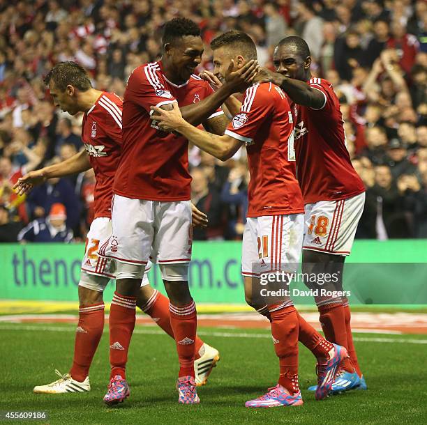 Jamie Paterson of Nottingham Forest celebrates with team mates Britt Assombalonga and Michail Antonio after scoring their fifth goal during the Sky...