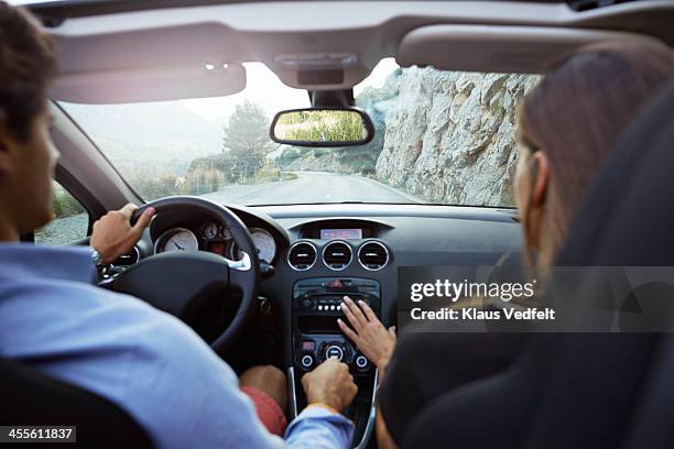 couple driving car, rear view - armaturenbrett stock-fotos und bilder