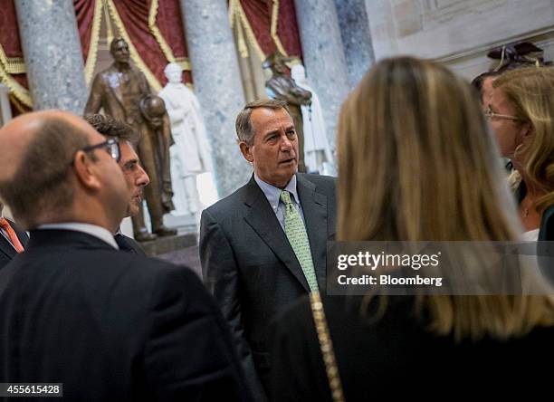 House Speaker John Boehner, a Republican from Ohio, speaks with members of the Italian Parliament after leaving the House chamber following a vote on...