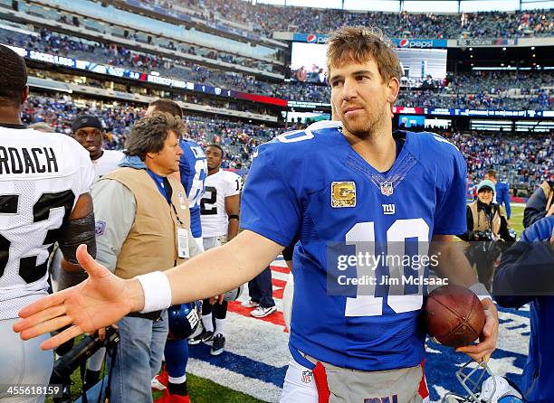 Eli Manning of the New York Giants in action against the Oakland Raiders on November 10, 2013 at MetLife Stadium in East Rutherford, New Jersey. The...