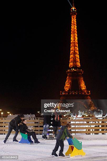 People skate on an ice skating rink across from the Eiffel Tower on December 12, 2013 in Paris, France. The event inaugurates the traditional Noel...