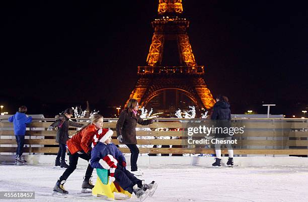 People skate on an ice skating rink across from the Eiffel Tower on December 12, 2013 in Paris, France. The event inaugurates the traditional Noel...