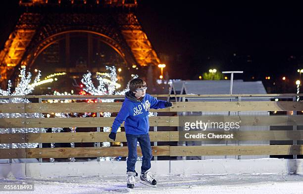 People skate on an ice skating rink across from the Eiffel Tower on December 12, 2013 in Paris, France. The event inaugurates the traditional Noel...