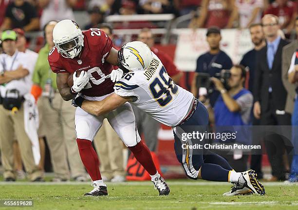 Running back Jonathan Dwyer of the Arizona Cardinals rushes the football against outside linebacker Jarret Johnson of the San Diego Chargers during...