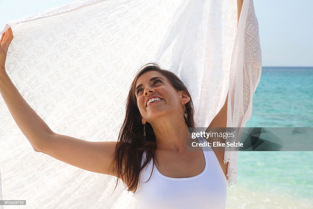 Close-up of woman looking upward on the beach