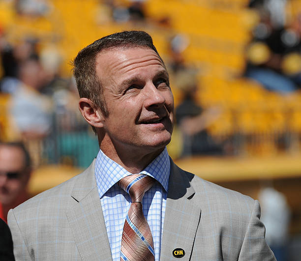 Merril Hoge, a football analyst for ESPN television and a former running back for the Pittsburgh Steelers and Chicago Bears, looks on from the...