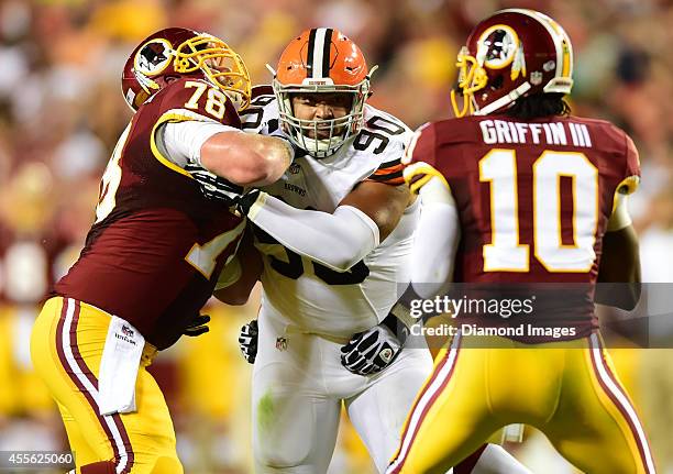 Defensive linemen Billy Winn of the Cleveland Browns gets off the block of offensive linemen Kory Lichtensteiger of the Washington Redskins during a...