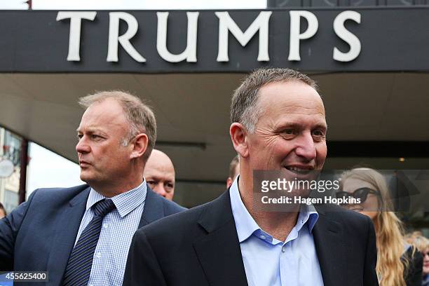 Prime Minister John Key and Palmerston North candidate Jono Naylor look on during a walkabout for the two-day National Party Bus Trip on September...