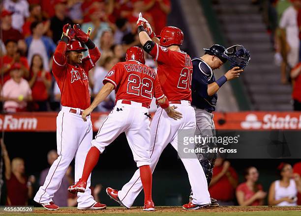 Erick Aybar, Tony Campana and C.J. Cron of the Los Angeles Angels of Anaheim celebrate Cron's three-run home run in the seventh inning, as Seattle...