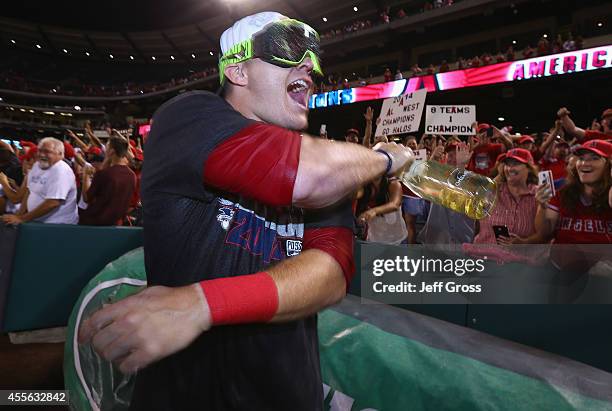 Mike Trout of the Los Angeles Angels of Anaheim celebrates with the fans after the Angels clinched the American League West Division at Angel Stadium...