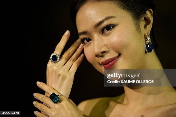 Model showcases a 17.16 carat step-cut unheated Kashmir sapphire and diamond Ring , a 35.72 carat step-cut Colombian emerald and diamond ring at a...