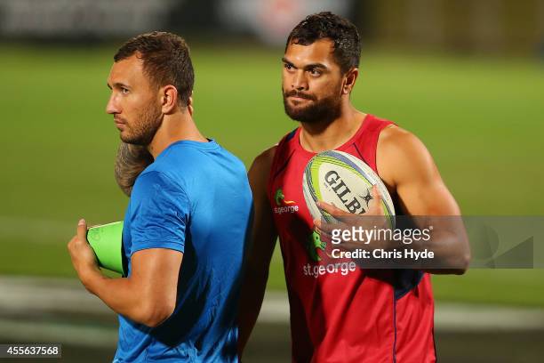 Quade Cooper and Karmichael Hunt talk during a Queensland Reds training session at Ballymore Stadium on September 18, 2014 in Brisbane, Australia.