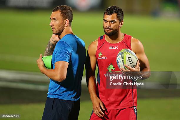 Quade Cooper and Karmichael Hunt talk during a Queensland Reds training session at Ballymore Stadium on September 18, 2014 in Brisbane, Australia.