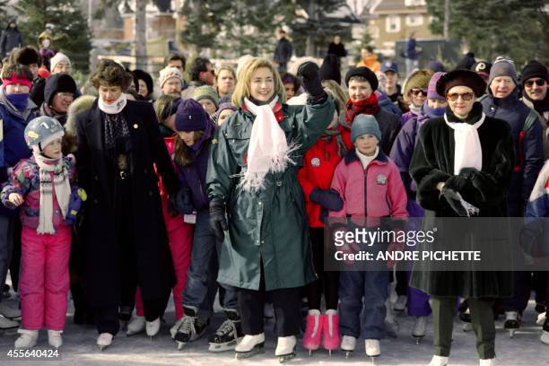 First Lady Hillary Clinton skates on the Rideau Canal on February 24, 1995 with Canadian Prime Minister wife Aline Chretien while waving at a local...