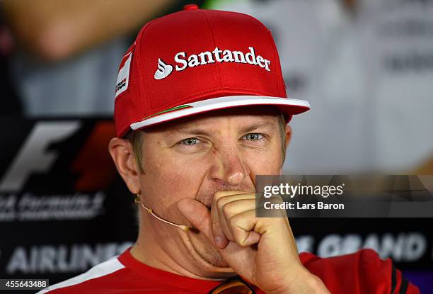 Kimi Raikkonen of Finland and Ferrari yawns at a press conference during previews ahead of the Singapore Formula One Grand Prix at Marina Bay Street...