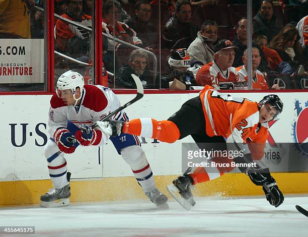 Alexei Emelin of the Montreal Canadiens trips up Matt Read of the Philadelphia Flyers during the first period at the Wells Fargo Center on December...