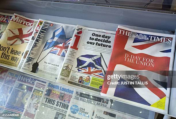 Front pages of national newspapers dispalying pictures and headlines related to Scotland's independence referendum are pictured on a newsstand in...